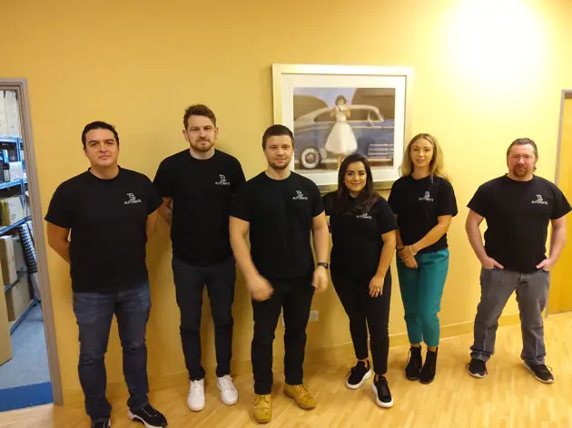 DAPA Solutions team standing outside their office wearing Home Automate t-shirts